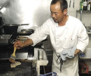 Chef Soo Song prepares a dish at main street bar and grill in Suisun city.